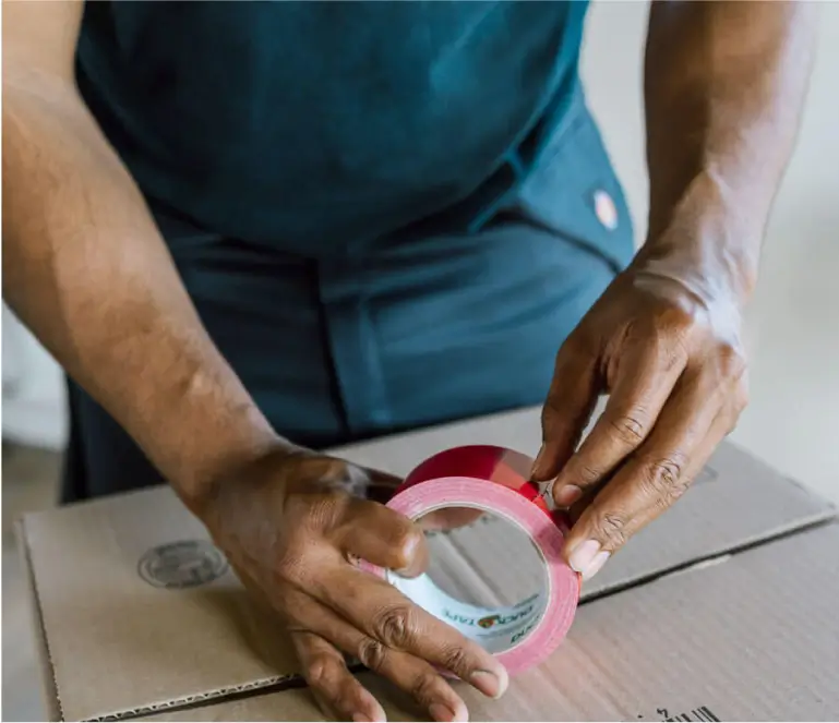 A person is wrapping a roll of tape
